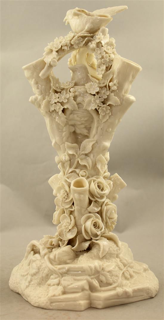 A Belleek bird and nest on a stump vase, late 19th century, 32cm, loss to bird
